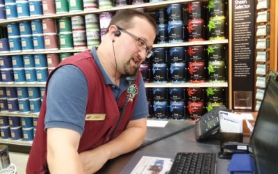 Coles Employee at Register on Phone with Customer