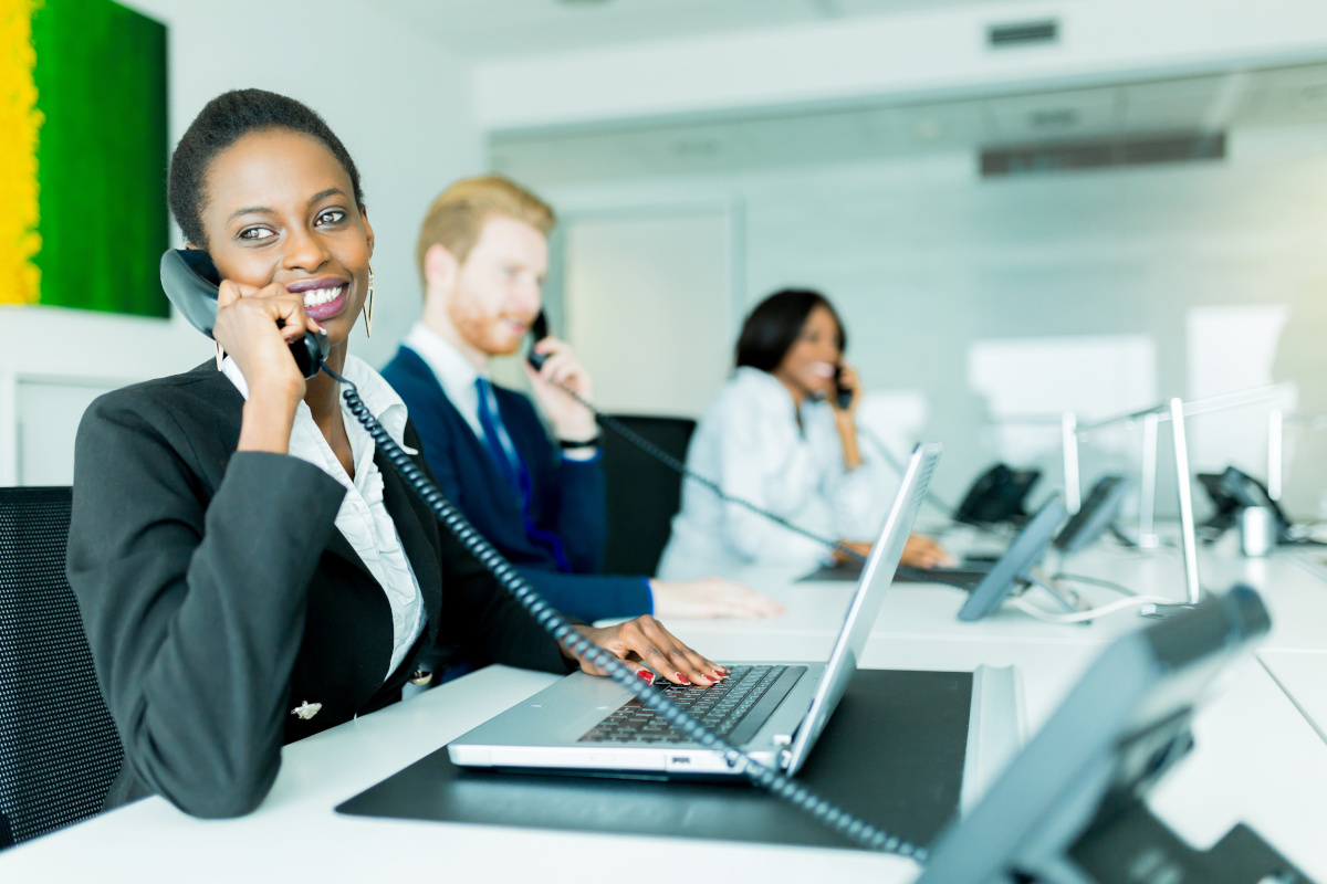 A team of employees answering eahc of their office phones