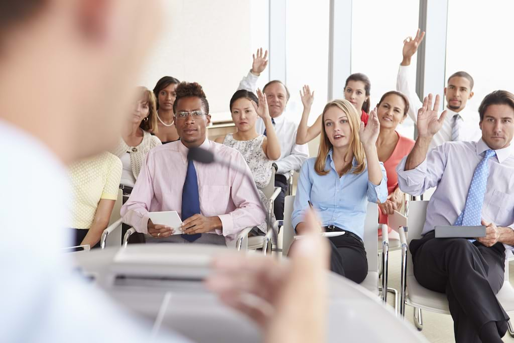 Delegates asking questions at business conference