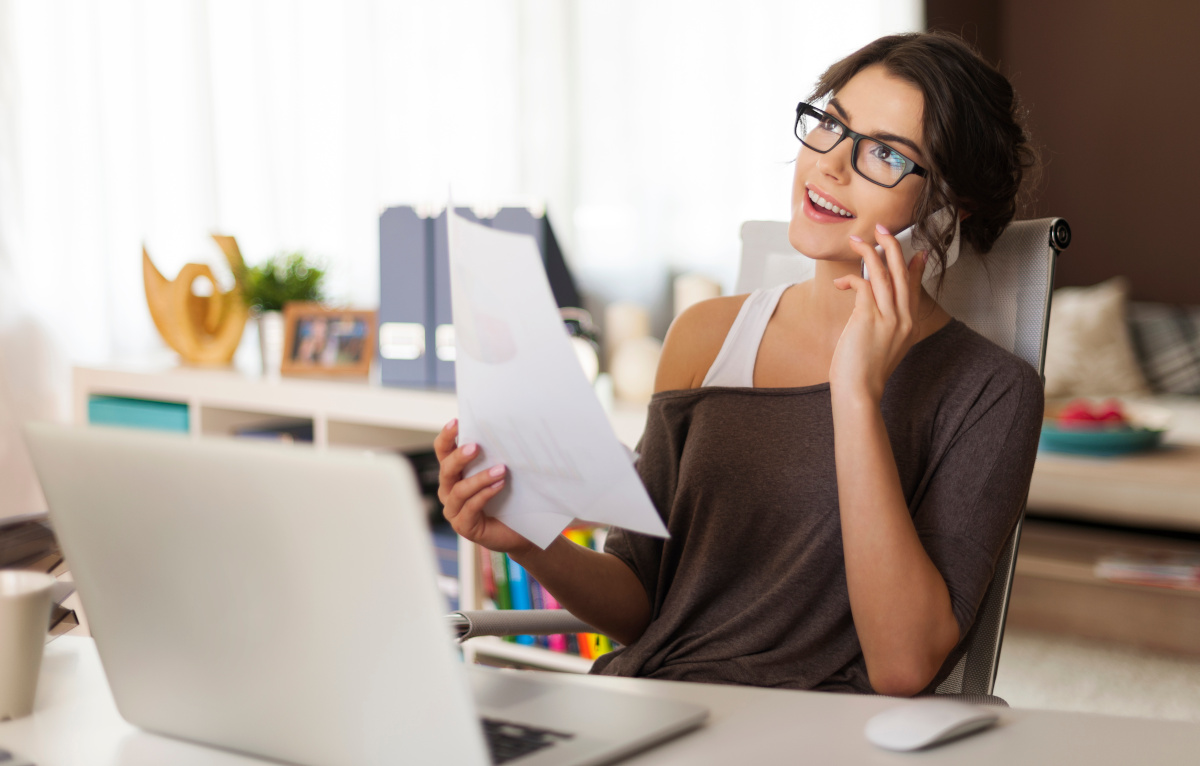 Smiling woman using mobile phone