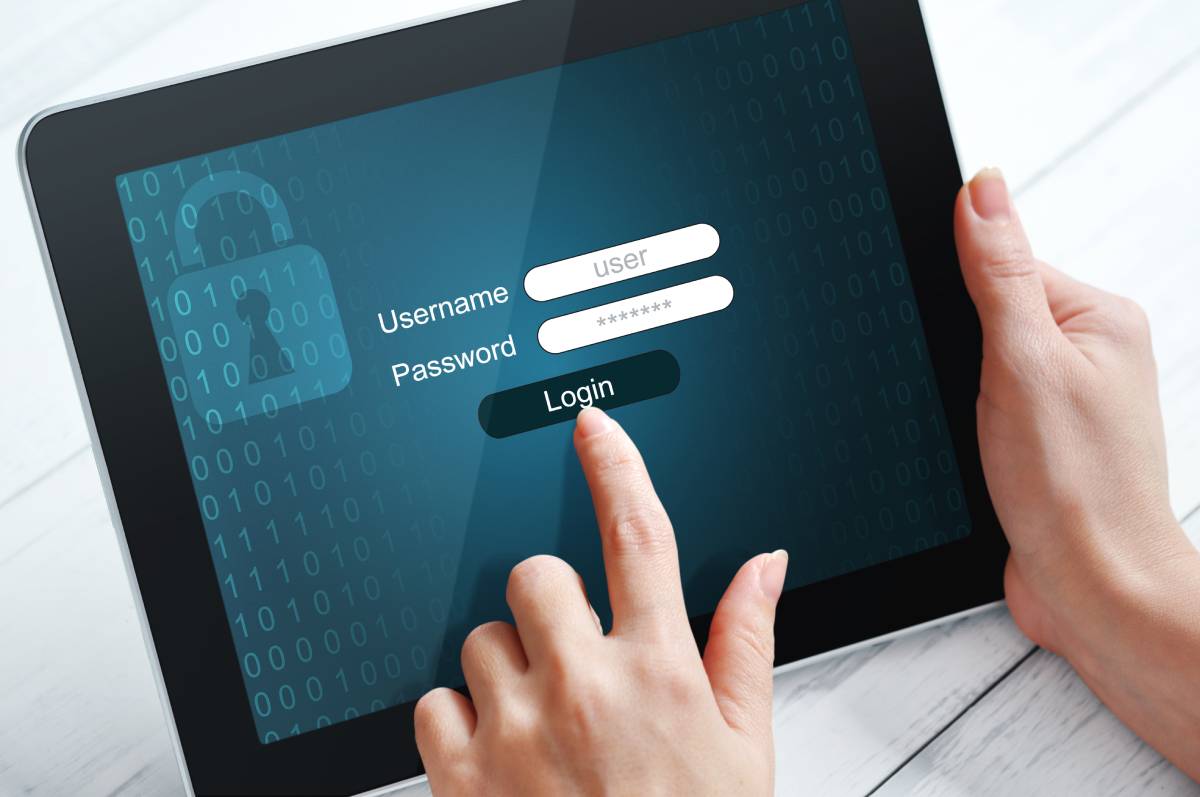 A woman's hands using a tablet protected with password username login